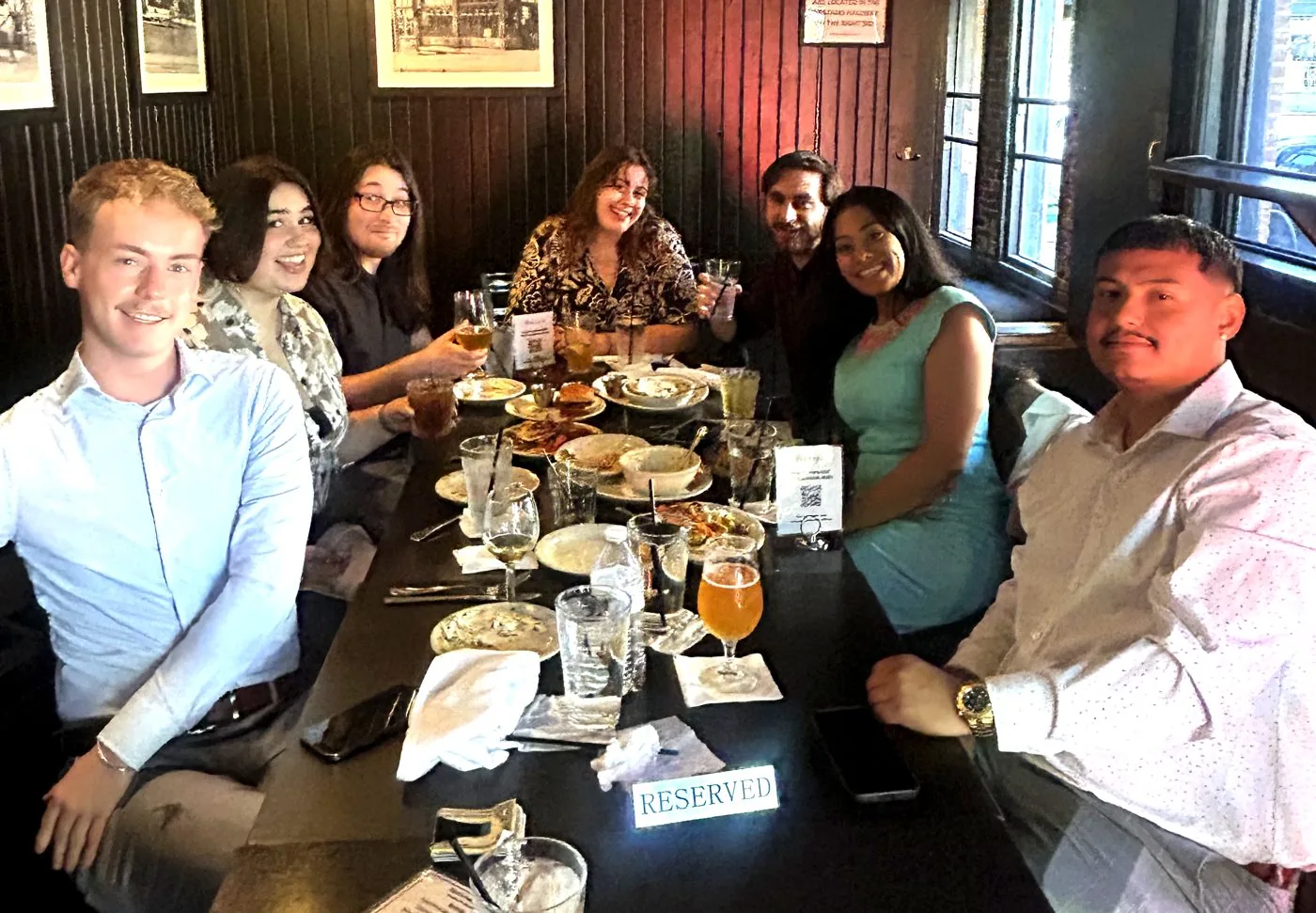 Members of the BluePeak Digital Insurance team seated together at a team dinner